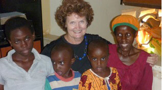 L to R: Harriet, her twin brothers Michael and Daniel, Jenni Prisk, Nalongo (Harriet's mother)