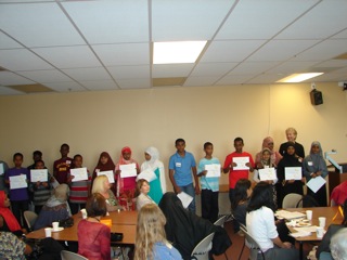 VOW Board Director Carol Clarke and UWEAST leader Sahra Abdi with the middle school recipients of the Essay Competition prizes